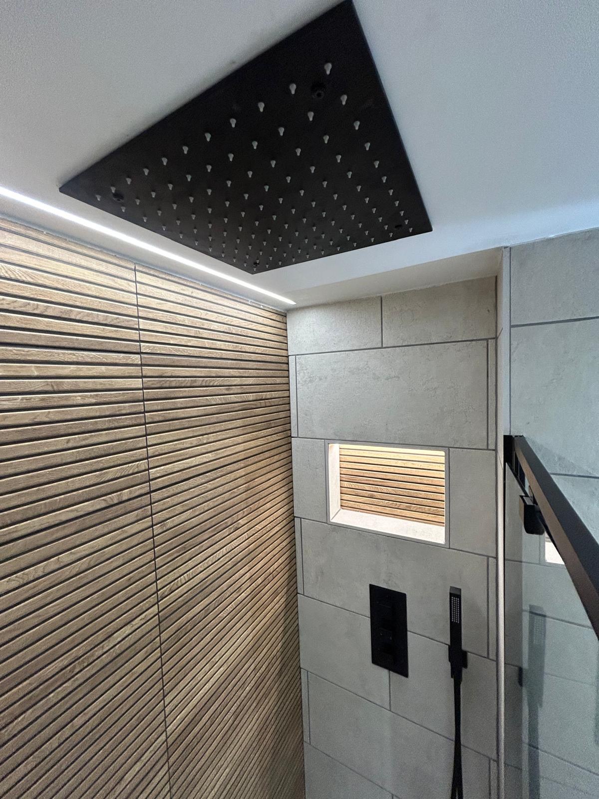 Shower room with black ceiling rainfall and slatted oak