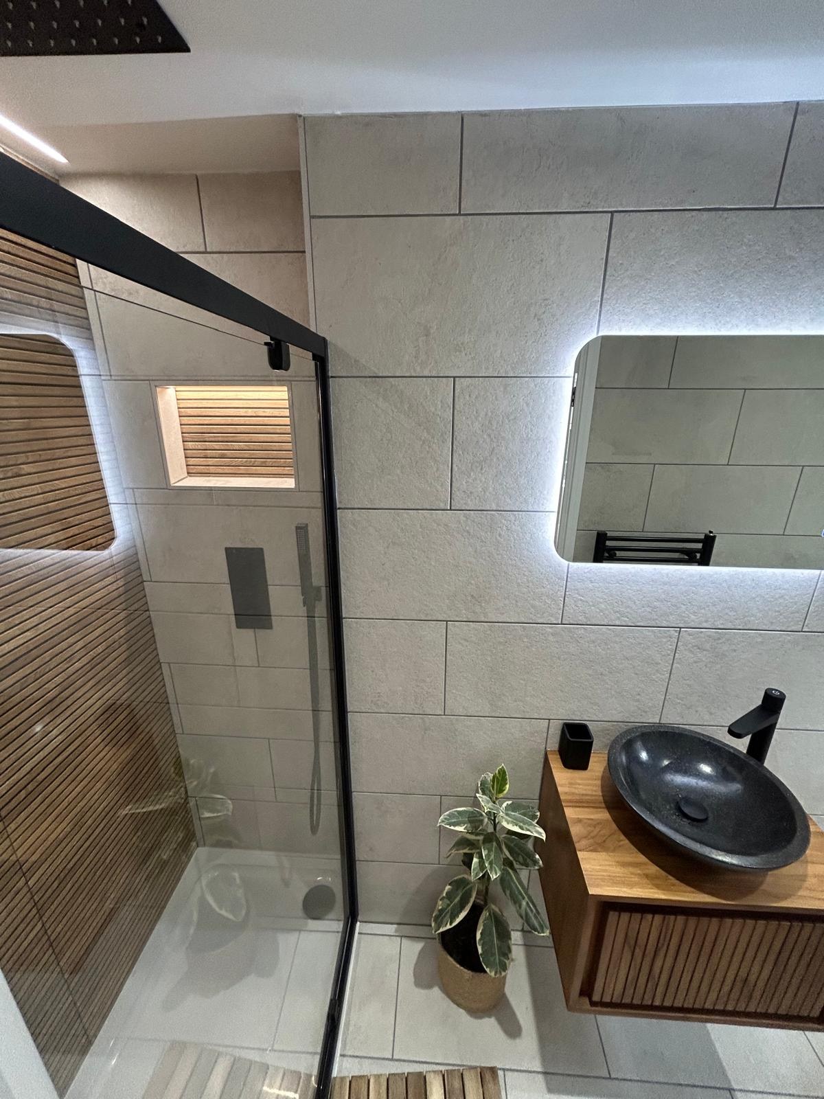 Contemporary shower room with black stone basin and oak vanity